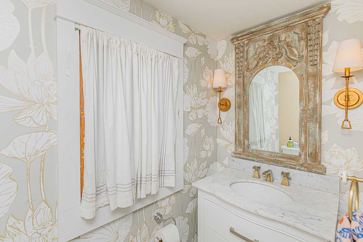 Bathroom remodel by BK Martin showing sink, mirror, and window.
