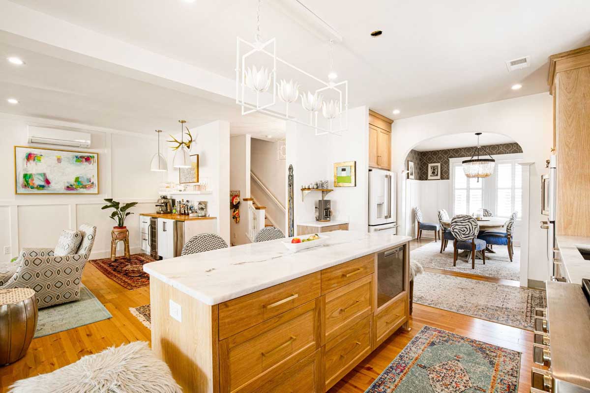 Kitchen by BK Martin showing island and natural lighting from dining room.