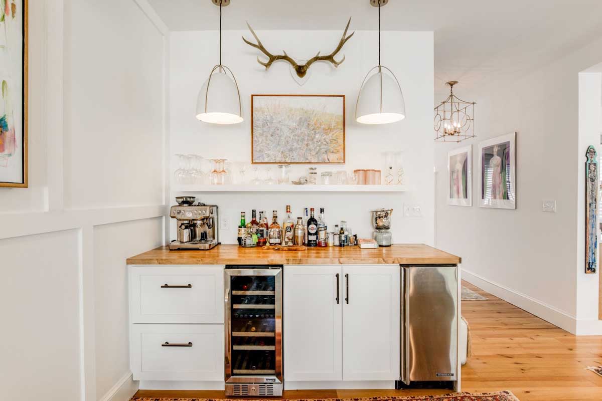 Small bar built by BK Martin showing espresso machine, glass bottles, mini-fridge, and whine cooler.