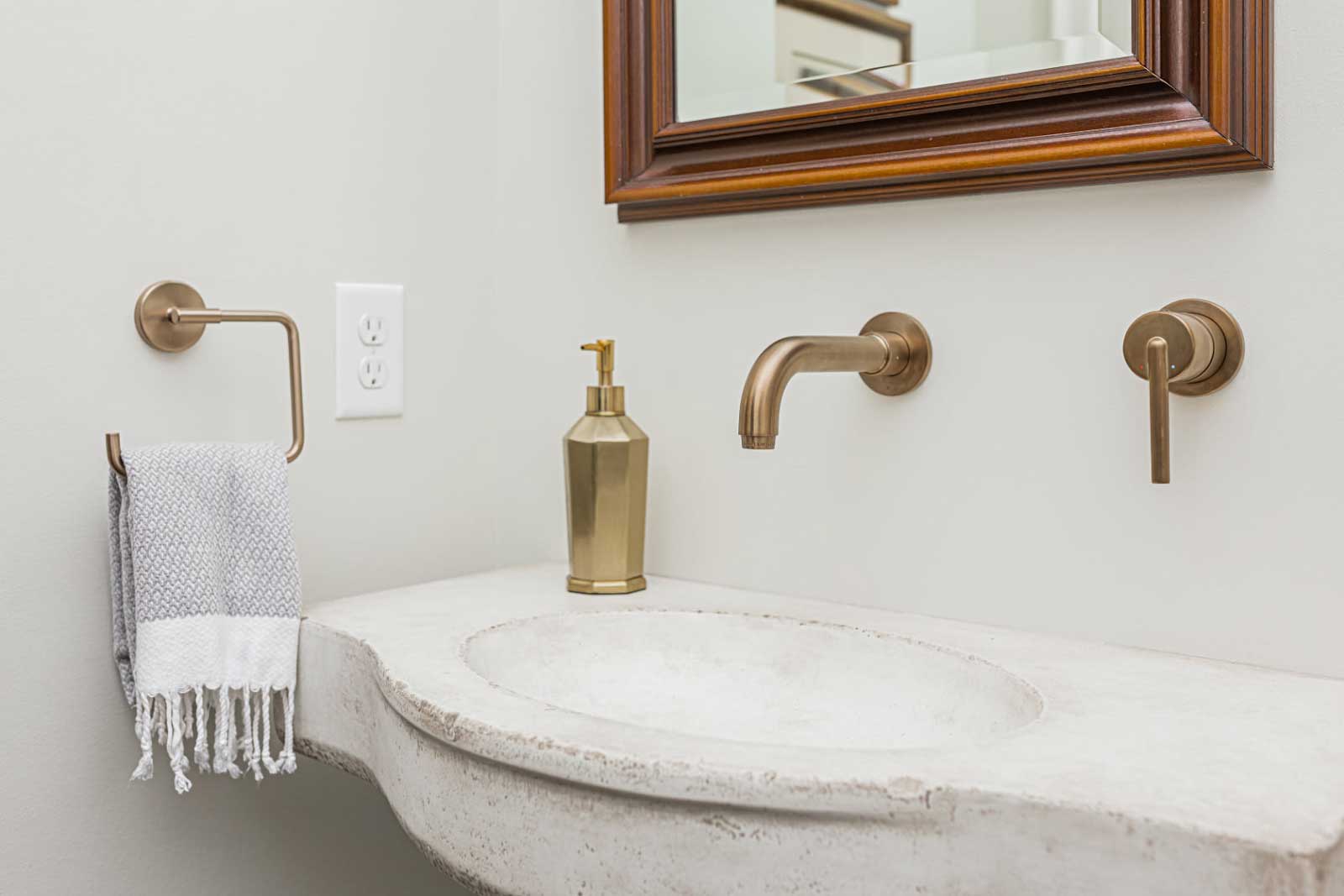 Coordinating copper fixtures surrounding a stone countertop with integrated sink