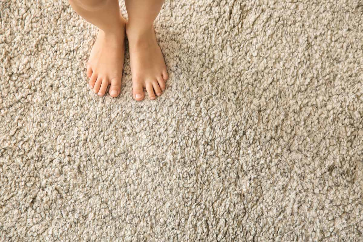 Bare feet on beige carpet
