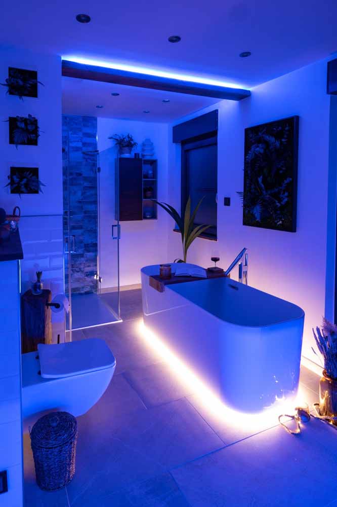 Modern bathroom with freestanding bathtub, modern taps and smart, LED ambient lighting