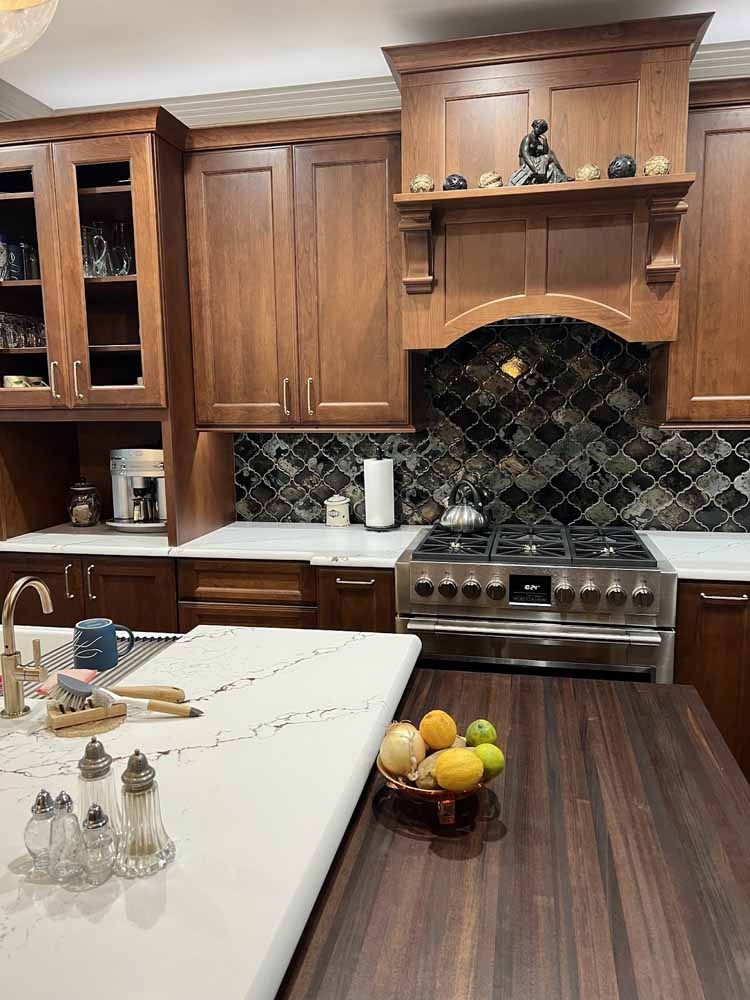 Gorgeous, black, arabesque shaped tiles used as the backsplash in this BK Martin kitchen remodel