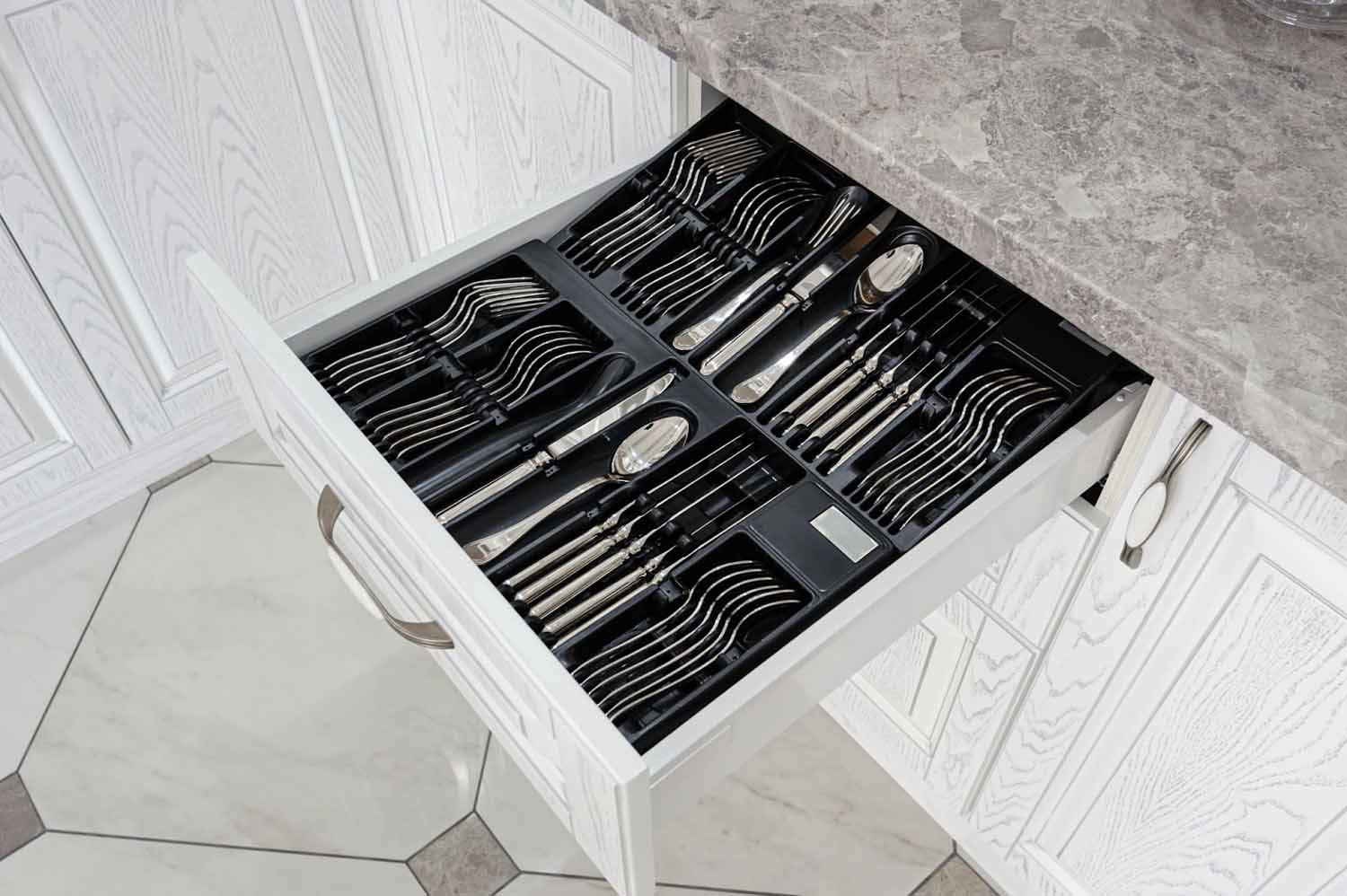 Open kitchen drawer with silverware organizer