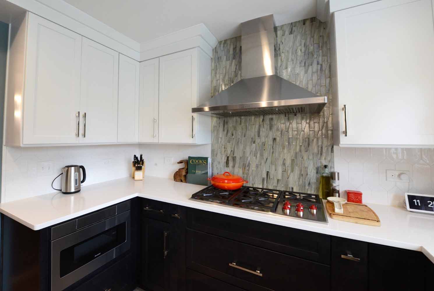 Mix-matched backsplash tiles offer a fun, unique look to this BK Martin home